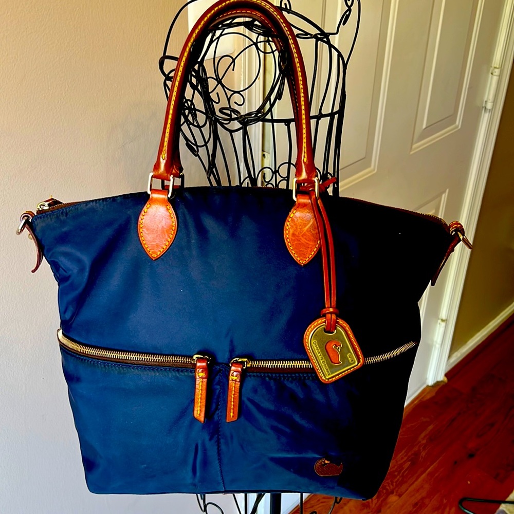 Dooney & Bourke nylon tote bag with leather handles and accents.